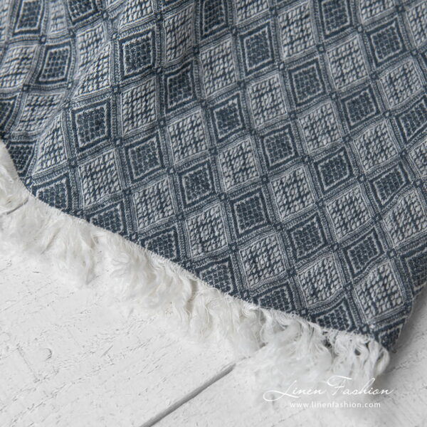 linen blanket with rhombus, with fringes on short sides.