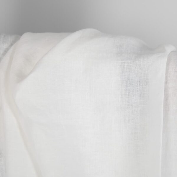 Washed linen fabric in off-white close up detail