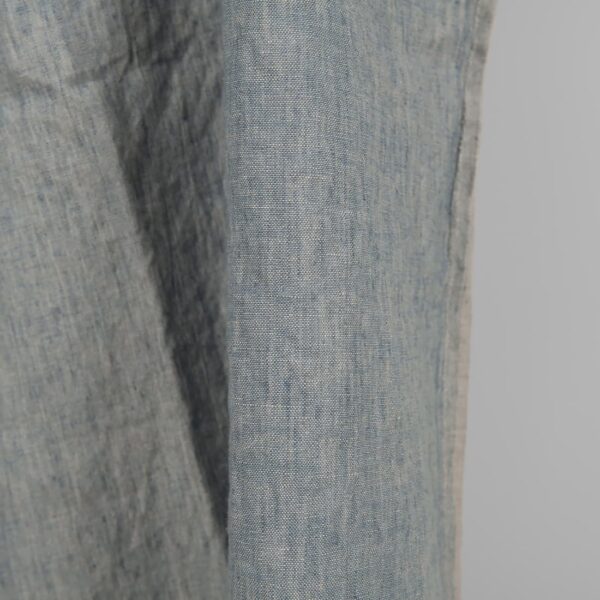 Linen washed fabric grayish blue color for sewing clothes and home textiles close edge view