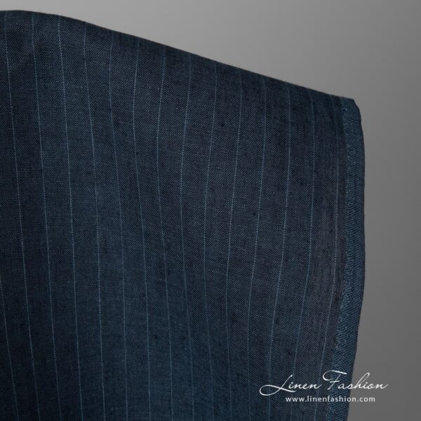 Dark blue striped linen fabric close up edge view