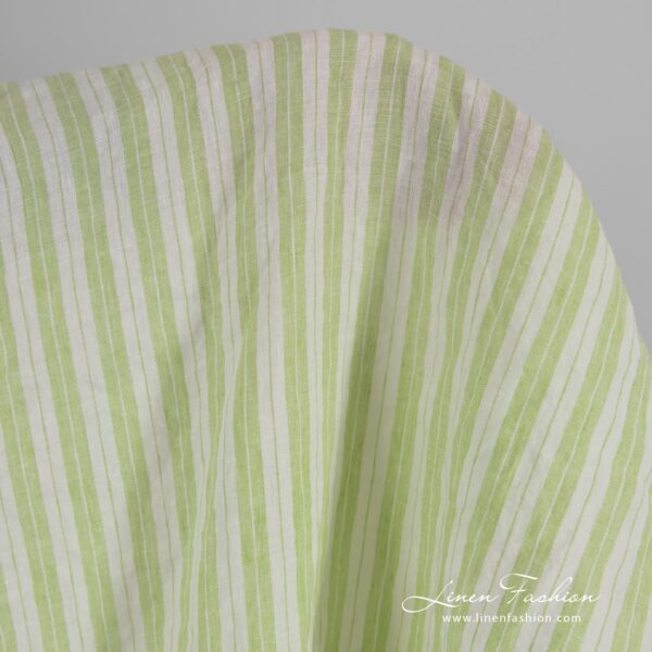 Light green linen fabric in stripes, washed