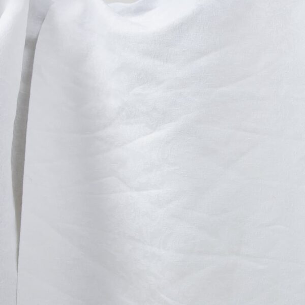 Optical white linen cotton fabric with flower ornaments product photo