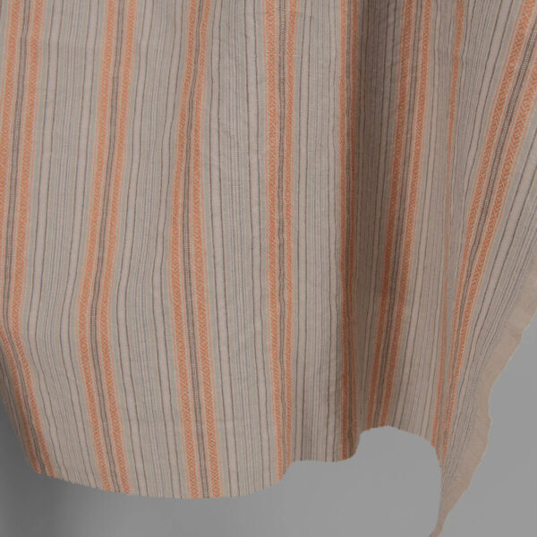 Washed linen cotton in brown patterned stripes edge view