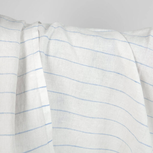 Washed linen cotton fabric white with sky blue stripes close up detail