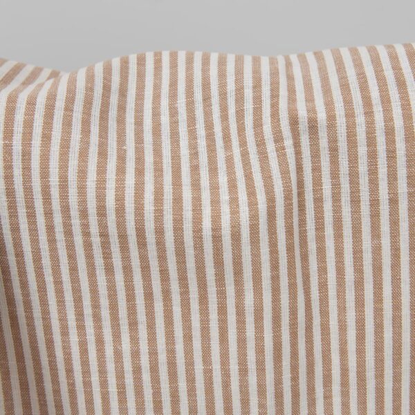 Wide linen cotton fabric in white and brown stripes close up detail