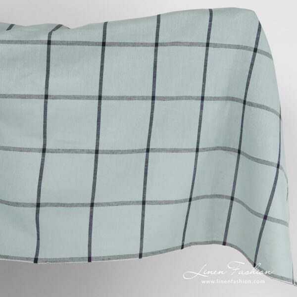 Pale blue linen cotton fabric with black grids.