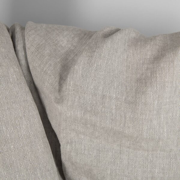 Openwork patterned linen fabric in beige close up detail