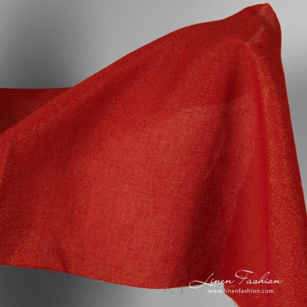 Red linen cotton fabric with golden lurex glitter.