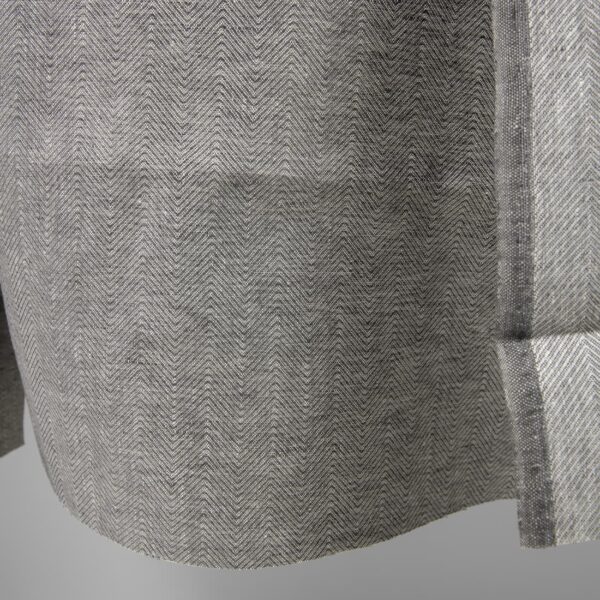 Linen fabric greyish brown in herringbone pattern edge