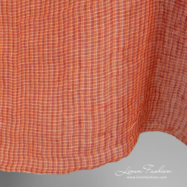 Linen fabric in melange, woven from orange, red and yellowish yarns