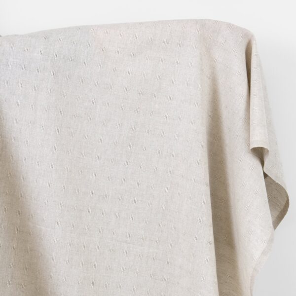 Tessuto in lino e cotone beige con motivo traforato